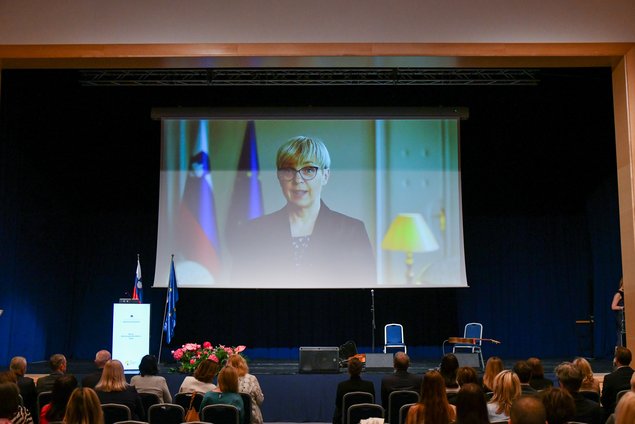 Video projekcija na odru, na platnu predsednica Republike Slovenije